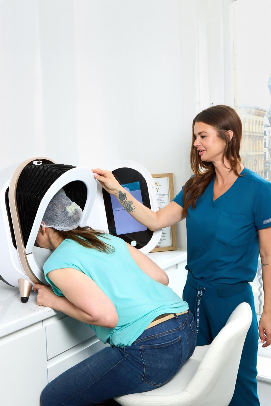 Derma Cosmedic practitioner performing a professional skin analysis consultation with a female client using an OBSERV facial analysis device at the Castle Street Liverpool clinic